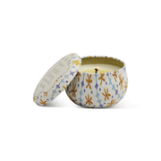 The Garden & Grove - Tulip 2 oz Tin Candle features a round tin with a colorful floral pattern and matching lid. Inside, the ivory, single-wick candle offers a fresh tomato vine scent, all presented on a plain white background.