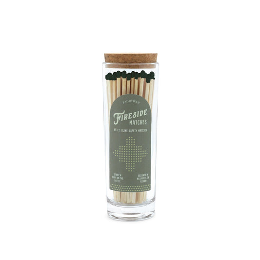 5.25" green-tipped matches in tall glass tube with cork stopper; green label on the side reads “Fireside Matches”; 85 matches inside