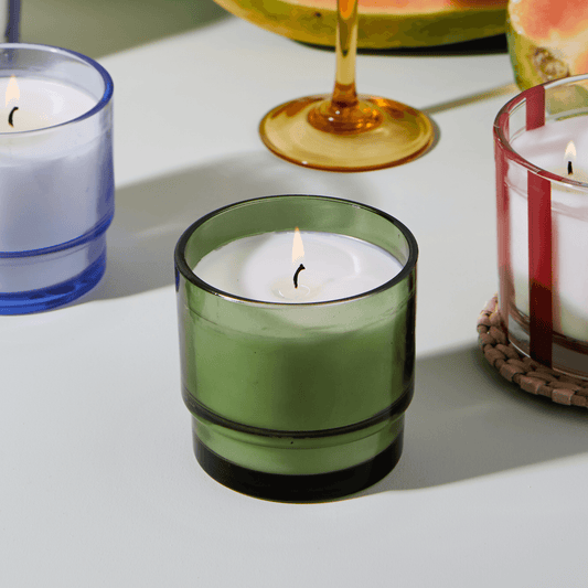 7 oz candle in glass vessel tinted green; white wax; one wick; a part of the Al Fresco collection; picture next to other candles of the Al Fresco collection