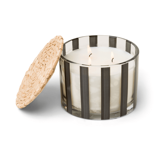 clear glass vessel with black stripes, white wax, and three wicks; a part of the Al Fresco collection; comes with woven rattan lid; 12 oz