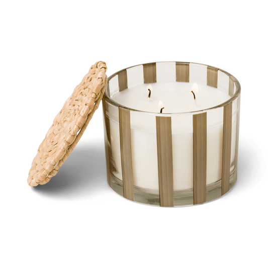 Striped brown clear glass vessel with white wax and three wicks; a part of the Al Fresco collection; comes with woven rattan lid; 12 oz