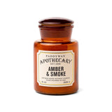 The Amber + Smoke - Apothecary 8 oz Candle is a brown glass soy wax candle with a sealed lid—perfect for those who appreciate elegant, vintage-inspired home fragrances.