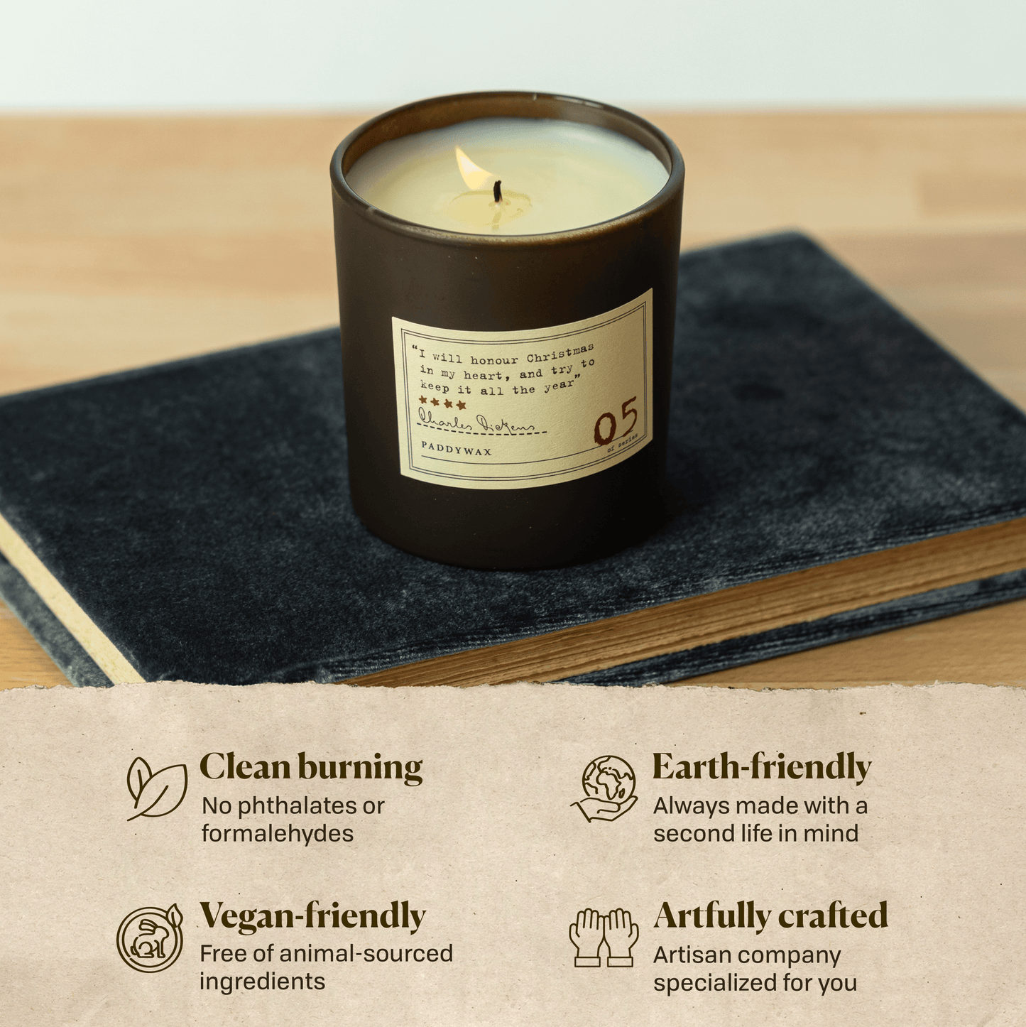A photo of the Charles Dickens candle sitting on a book. Clean burning: no phthalates or formaldehydes. Earth-friendly: Always made with a second life in mind. Vegan-friendly: Free of animal sourced ingredients. Artfully crafted: Artisan company specialized for you.