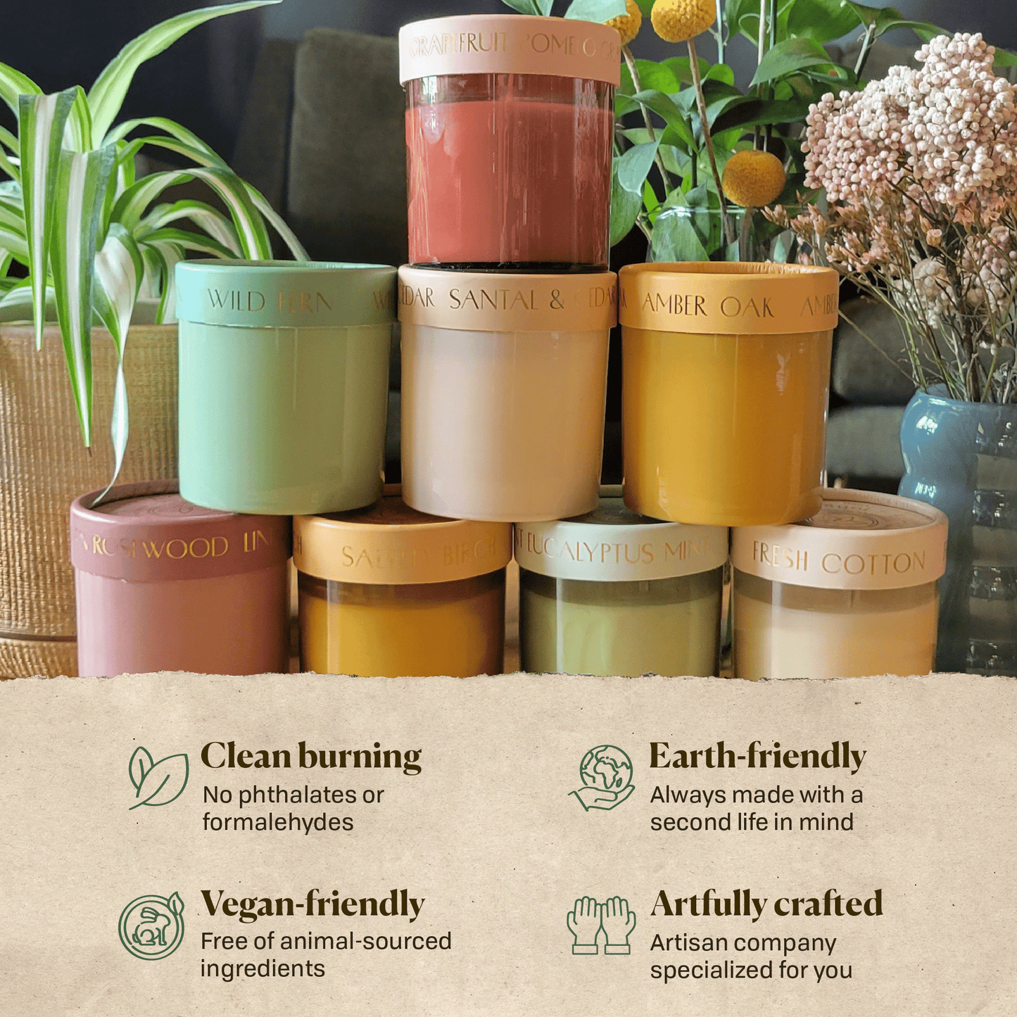All 8 scents of the optimist candles in a pyramid stack.  Writing on the image says clean burn, earth friendly, vegan friendly and artfully created