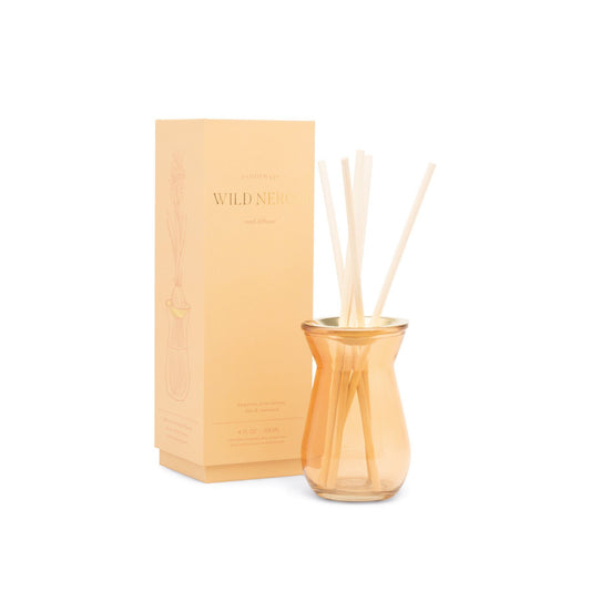4 oz. orange glass diffuser with a brushed gold metal plate; pictured with bamboo sticks inside, in front of the orange package