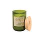 Candle in an 8 oz green glass vessel with a beige label and a wooden lid