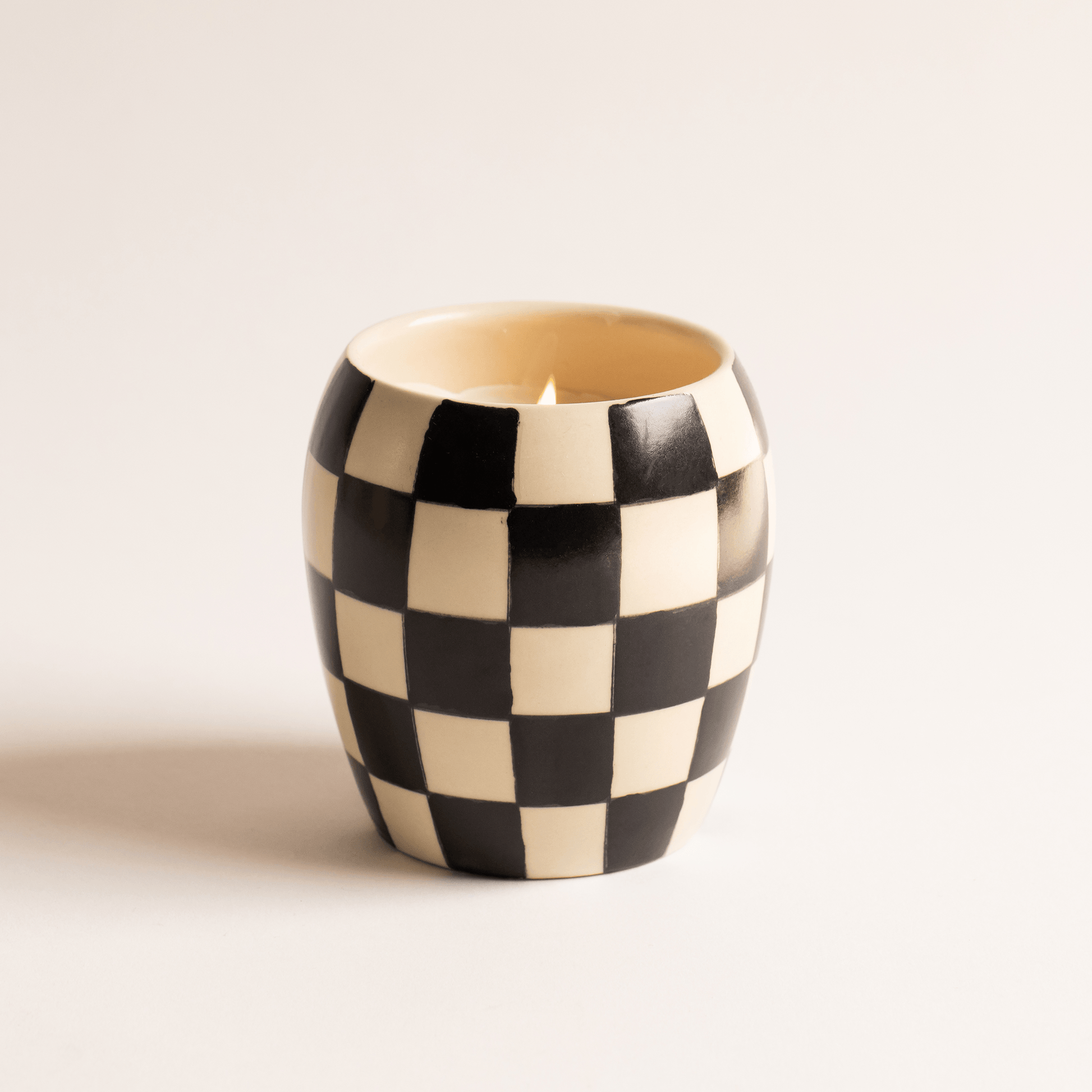 11 oz ceramic vessel with rounded cylindrical shape and a black/white checker design; one cotton wick