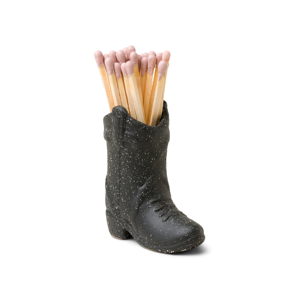 small black ceramic cowboy boot pictured holding pink-tipped matches
