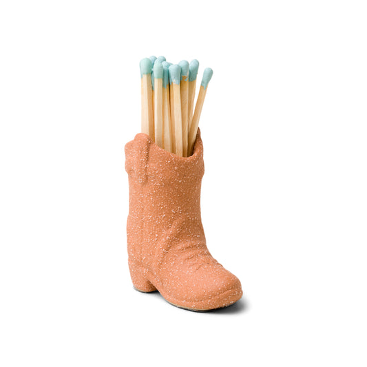 terracotta (desert orange) ceramic cowboy boot pictured holding blue-tipped matches