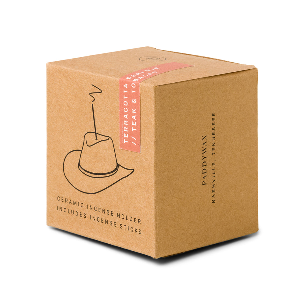 brown box packaging with outline of the ceramic cowboy hat holding an incense stick