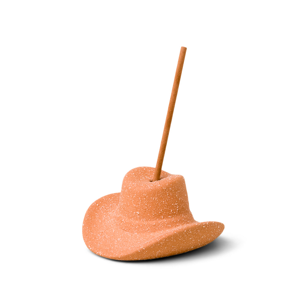 Terracotta (desert orange) ceramic cowboy hat holding incense stick in the top