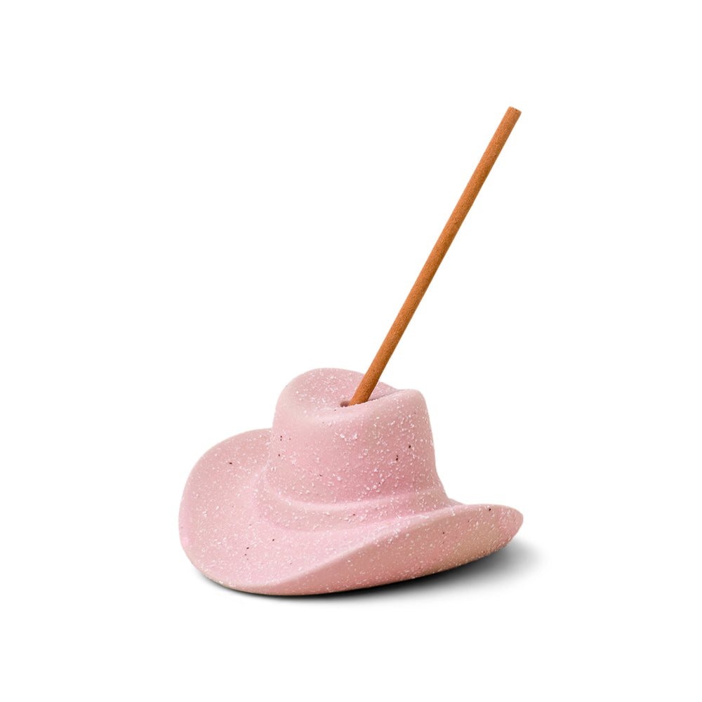 Pink ceramic cowboy hat holding incense stick in the top