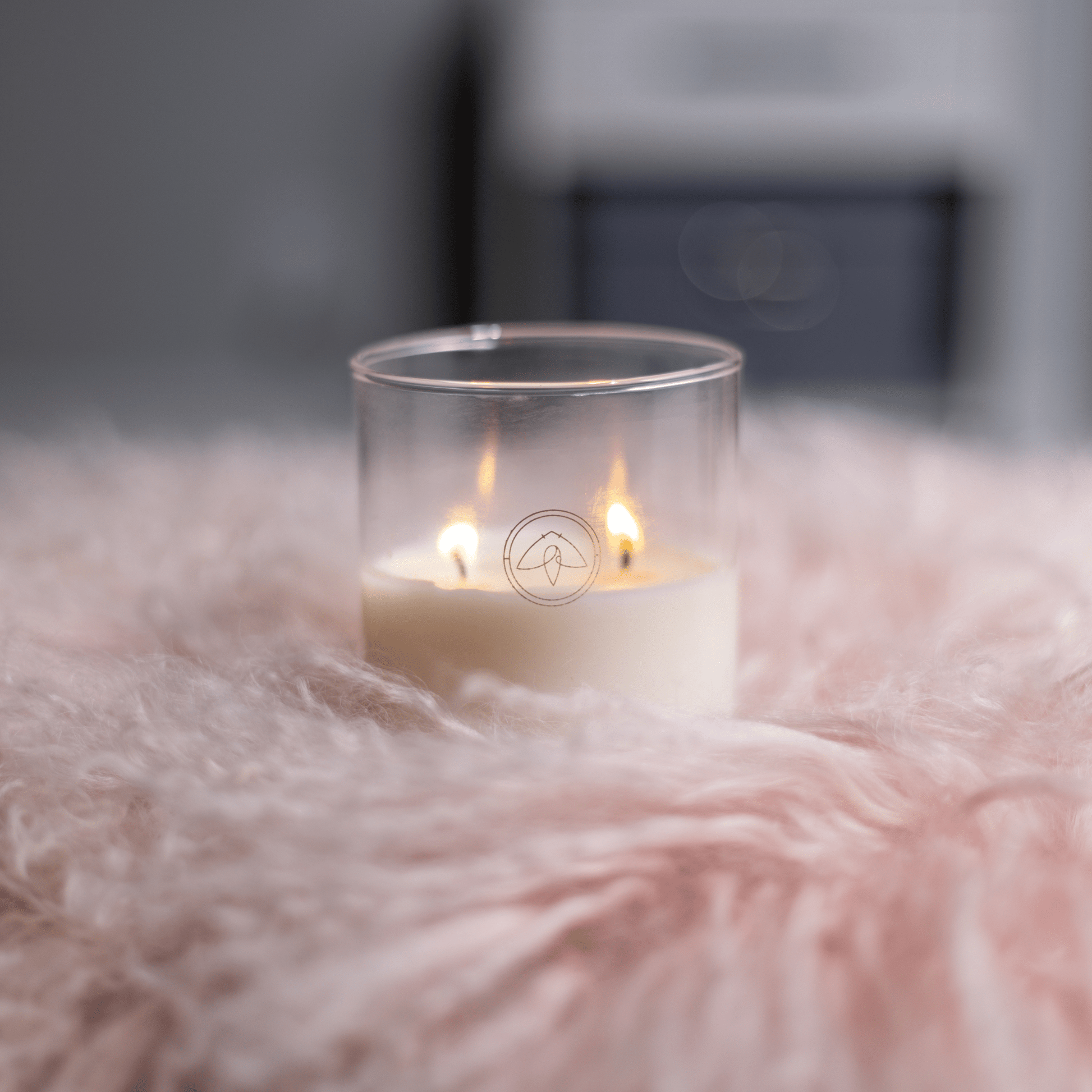 10oz Clarity two wick candle on light colored shag blanket