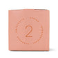 Pink box with "the helper" printed on the front; Also has the number 2 printed on the side