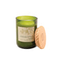 Candle in an 8 oz green glass vessel with a beige label and a wooden lid