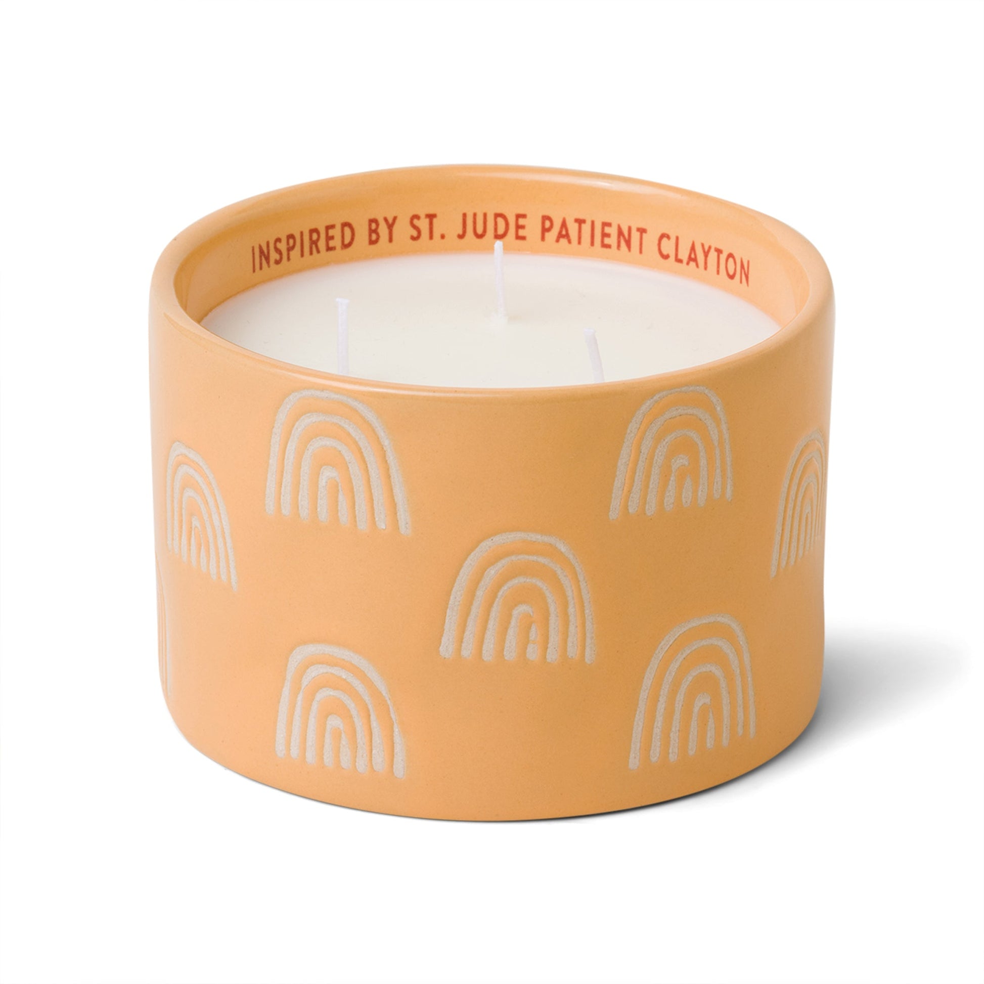 Yellow ceramic candle with rainbows and white soy wax center with three wicks. Debossed name on back side of the label with text "Inspired by St. Jude patient Clayton". Scented candle on white background