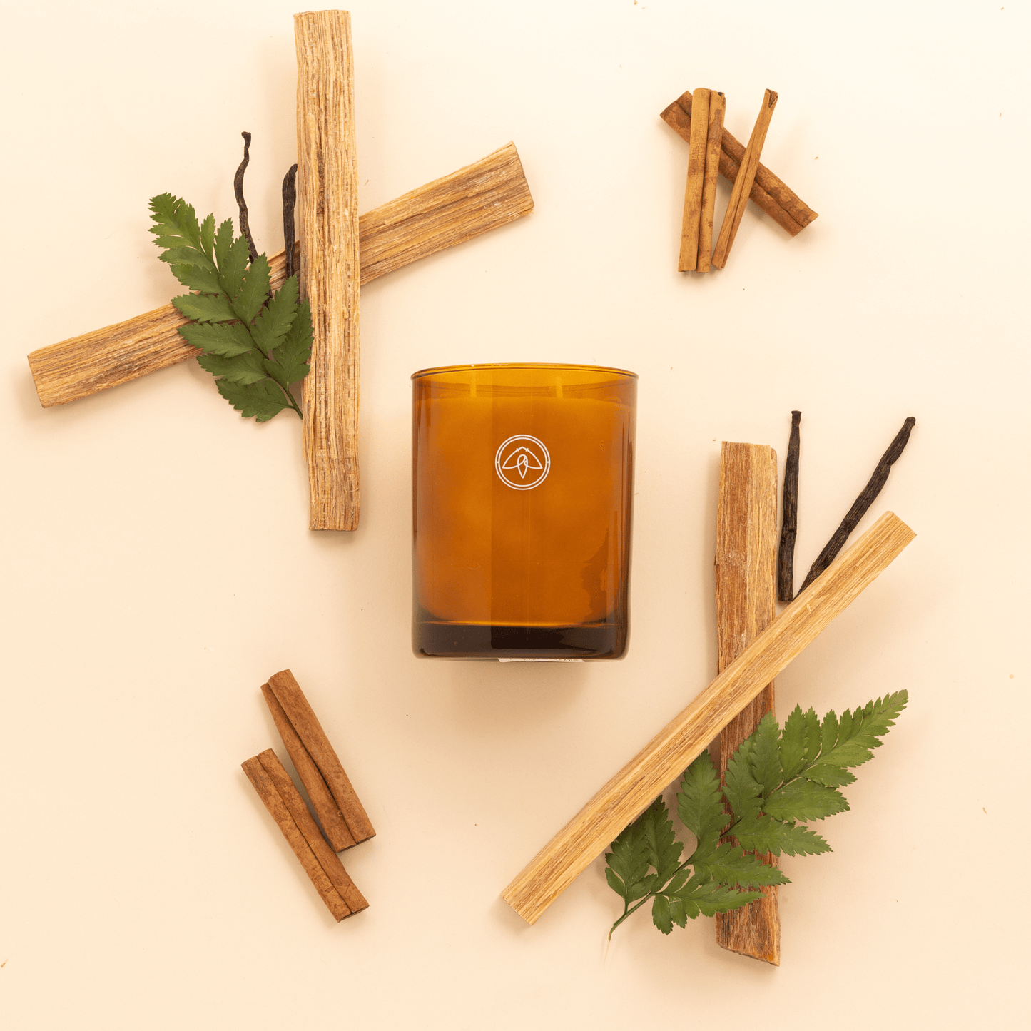 Products Glow 10oz. Candle - Vintage Leather unlit two wick candle with greenery and wood chips on cream background