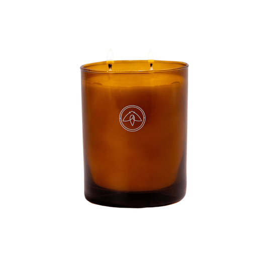 Glow Mandarin Musk 10 oz candle in an amber vessel with 2 wicks