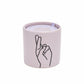 Impressions 5.75 oz Candle - Wisteria + Willow "Fingers Crossed" - purple colored vessel with black outlined hand with fingers crossed