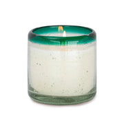 The Cactus Flower Bamboo - La Playa 9 oz Candle features a white candle in a transparent green hand-blown holder made from recycled glass, shown on a plain white background.