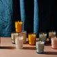 The Noel candle collection with all candles lit.  10 candles showing, 6 total varieties of candle fragrance in this collection
