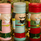 Nutcracker candles with lids on and Christmas decor