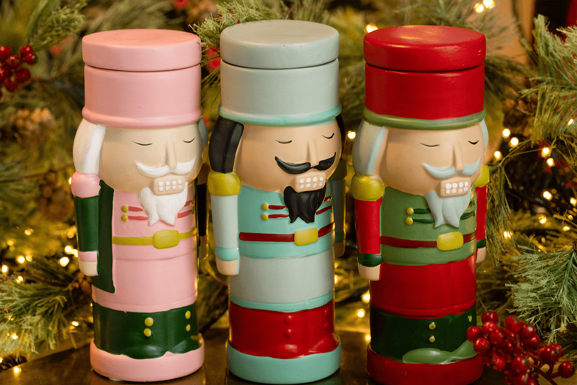 Nutcracker candles with lids on and Christmas decor