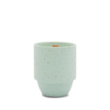 An Olympic - Parks 11 oz Candle, light green with speckled ceramic, features a rounded bottom and straight sides, reminiscent of national park designs, shown against a plain white background.