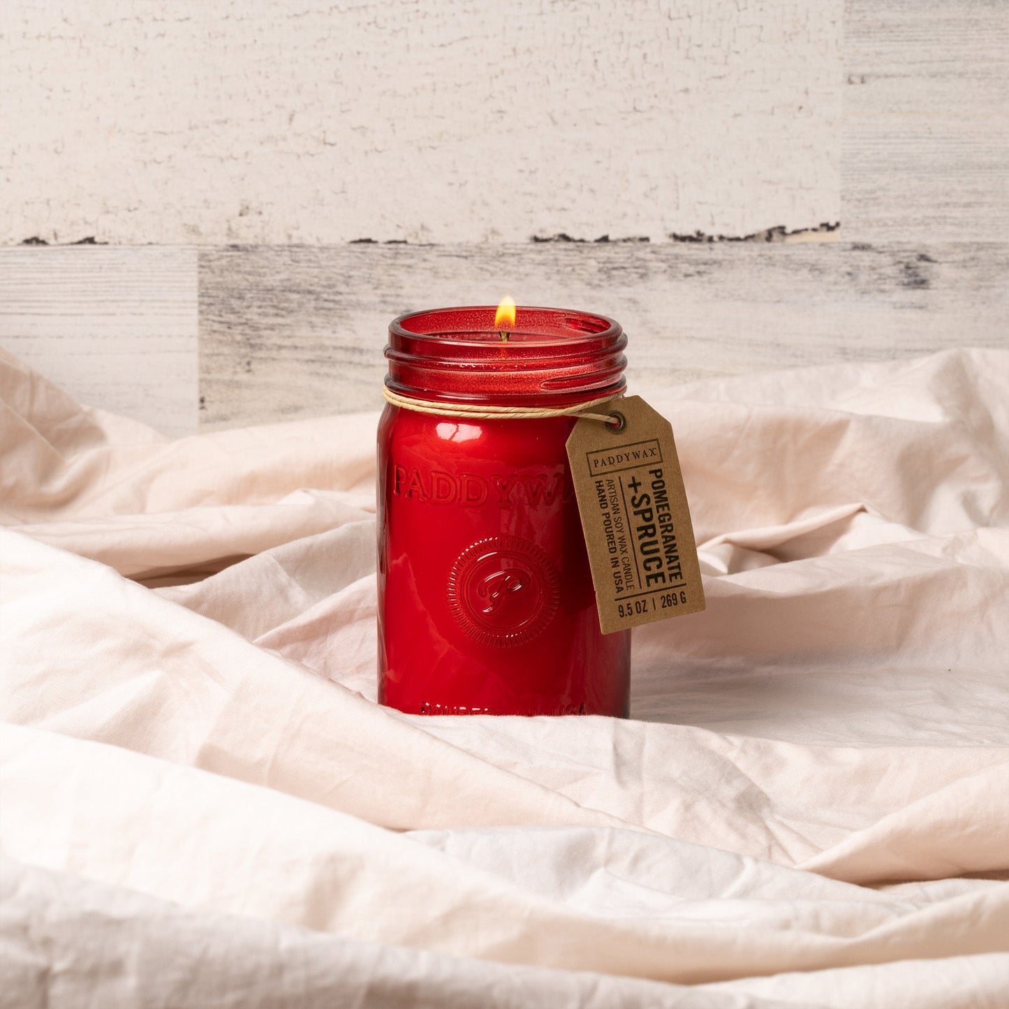 Relish pomegrante spruce candle on a table cloth