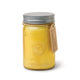 The Relish 9.5 oz. Candle - Fresh Meyer Lemon comes in a yellow glass mason jar with a metal lid and brown tag, embossed with Paddywax and Poured in USA, adding charm and fresh fragrance to your space.