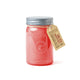 The Relish 9.5 oz Candle - Salted Grapefruit by Paddywax comes in a clear jar with pink wax and a labeled metal lid, offering an inviting fragrance in a charming and reusable container.