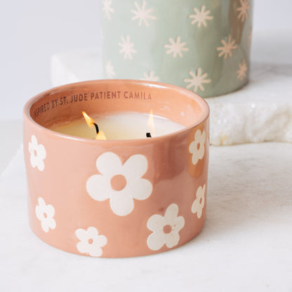 St. Jude pink ceramic candle burning