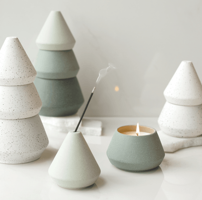 Small White Tree Stack taken apart; top part holding the incense stick and the bottom half (candle) lit