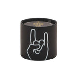 The Leather + Oakmoss "Rock On" Impressions 5.75 oz Candle comes in a black matte ceramic container with a white hand making the rock on gesture and "ROCK ON" in gold foil on the lid.